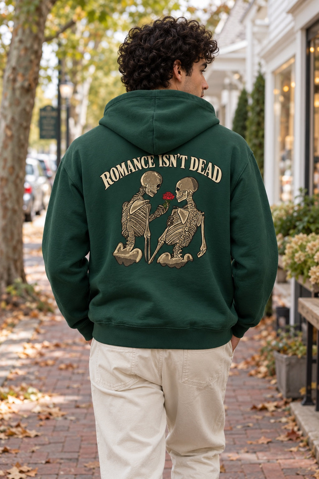 Romance Isn't Dead Forest Green hoodie, back print with two skeletons and a red rose